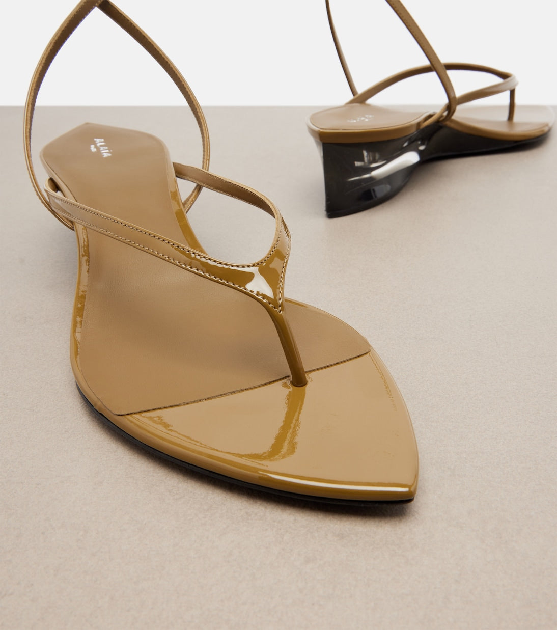 Alaia Invisible Patent Leather Wedge Thong Sandals